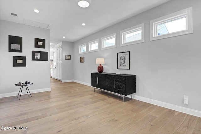 interior space featuring recessed lighting, light wood-type flooring, visible vents, and baseboards