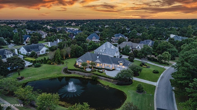 drone / aerial view with a residential view and a water view