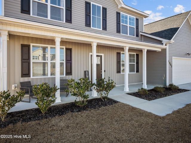 property entrance featuring a garage and a porch