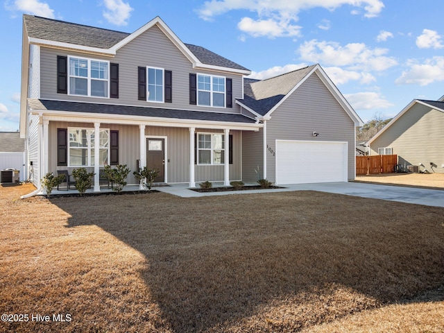 view of front property featuring a porch, central AC, a garage, and a front yard