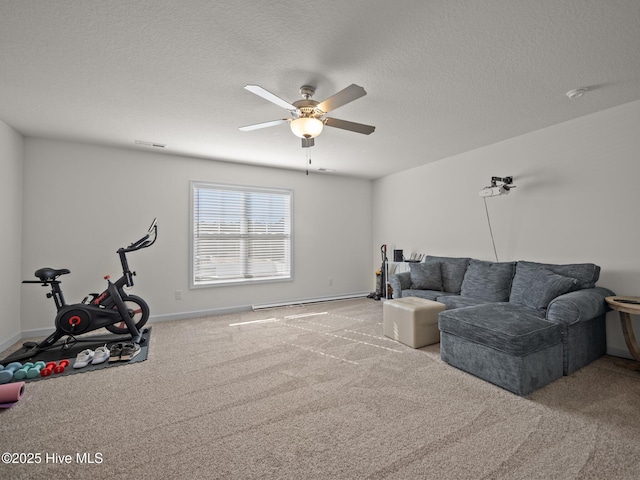 carpeted living room featuring ceiling fan and a textured ceiling