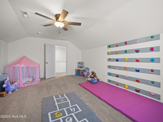 rec room with lofted ceiling, ceiling fan, a textured ceiling, and carpet flooring