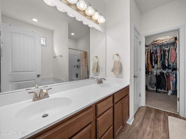 bathroom featuring vanity, hardwood / wood-style floors, and separate shower and tub