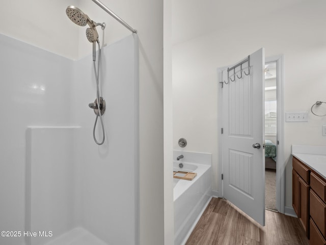 bathroom with vanity, shower with separate bathtub, and hardwood / wood-style floors