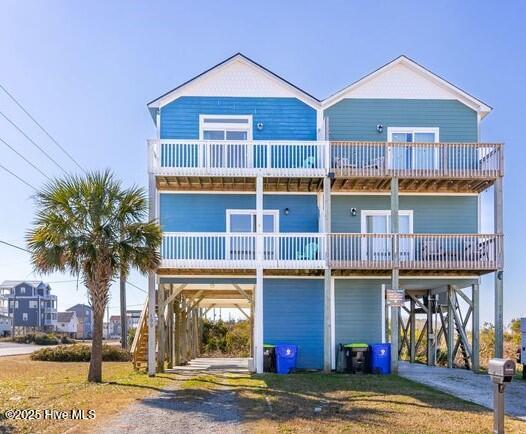 view of front of property featuring a balcony and a carport