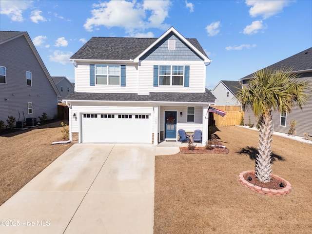 view of front of property featuring a garage, a front lawn, and central air condition unit