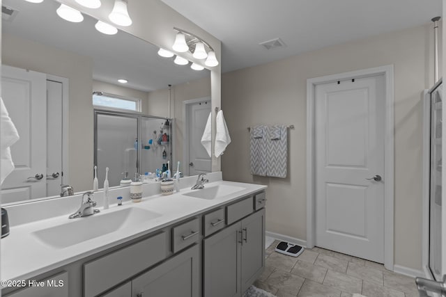 bathroom with vanity and a shower with shower door