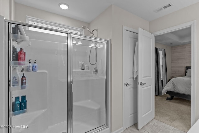 bathroom featuring a shower with shower door