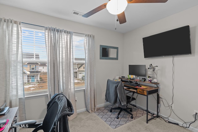 carpeted home office with ceiling fan