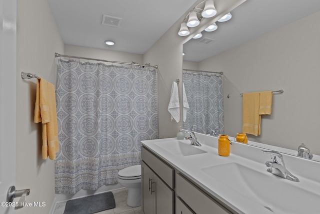 bathroom featuring tile patterned flooring, vanity, and toilet