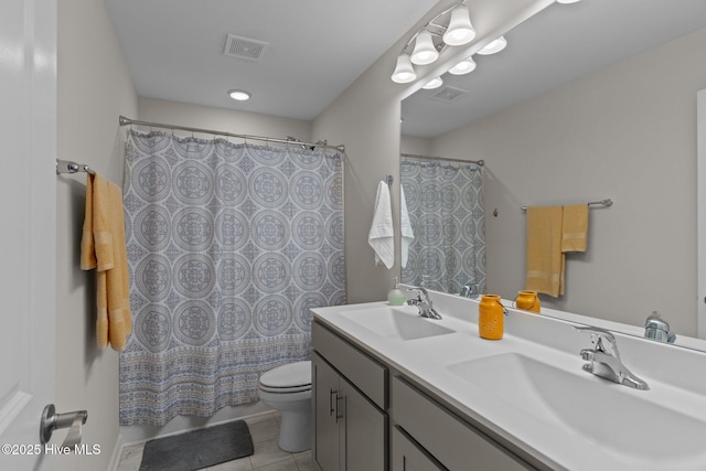 bathroom with a shower with shower curtain, vanity, toilet, and tile patterned flooring