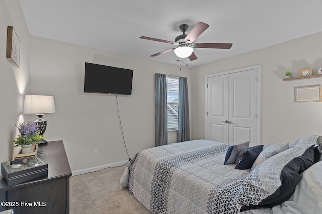 bedroom with light colored carpet, a closet, and ceiling fan