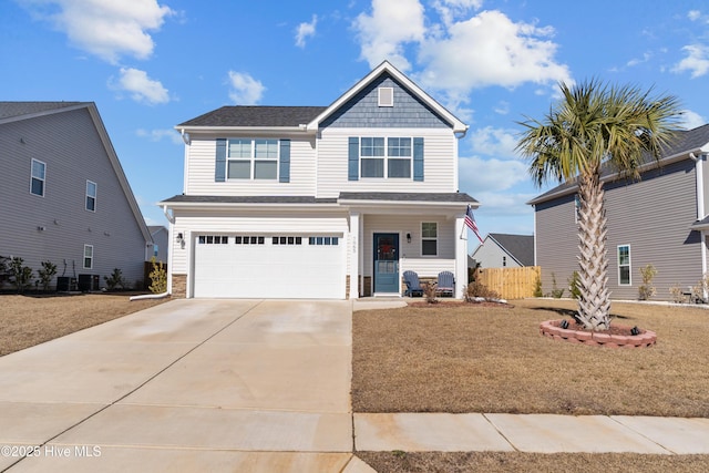 view of front of home with cooling unit, a garage, and a front yard