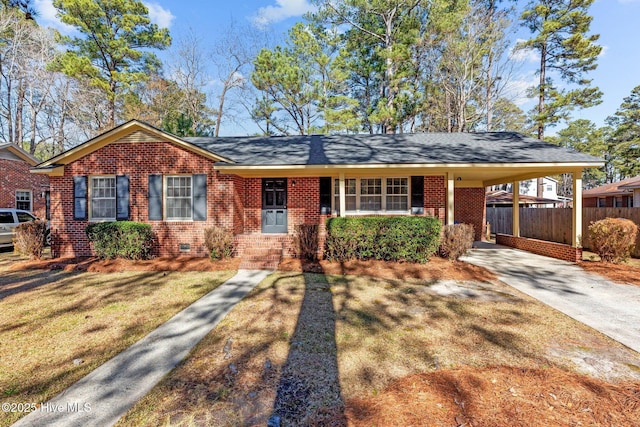 ranch-style home featuring a front yard and a carport