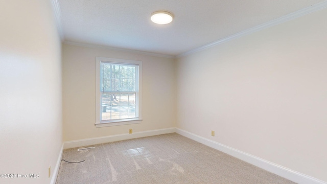 empty room with light colored carpet and ornamental molding