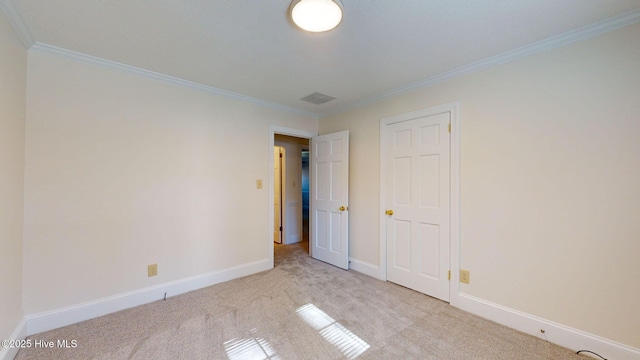 unfurnished bedroom featuring ornamental molding and light colored carpet