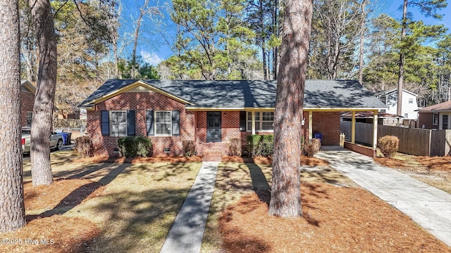 ranch-style home featuring a carport and a front lawn