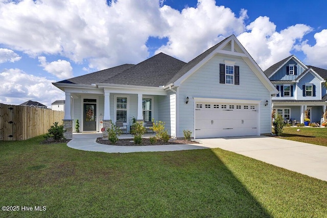 craftsman-style home with a garage, covered porch, and a front yard