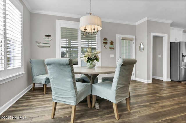 dining room featuring crown molding, a healthy amount of sunlight, and dark wood-type flooring