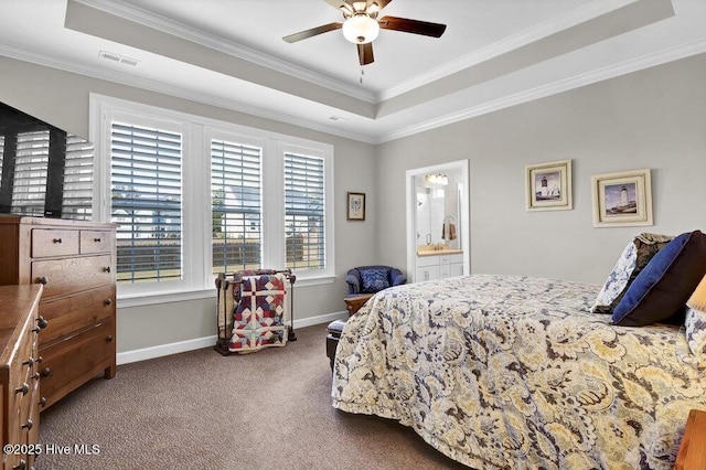 bedroom with connected bathroom, crown molding, a tray ceiling, ceiling fan, and carpet