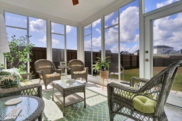 sunroom featuring ceiling fan