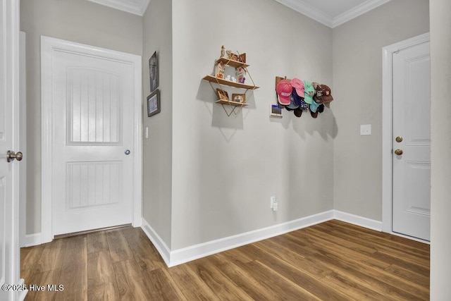 foyer entrance with ornamental molding and wood-type flooring