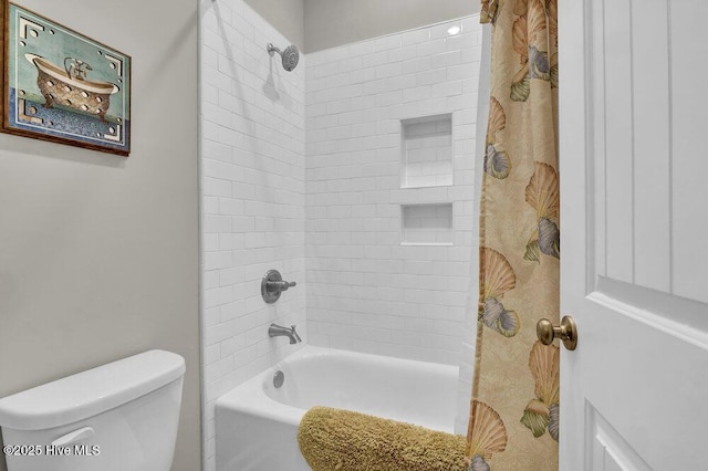 bathroom with shower / tub combo and toilet