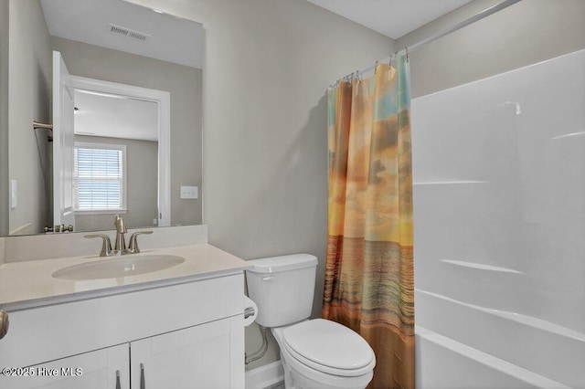 full bathroom featuring vanity, shower / tub combo, and toilet