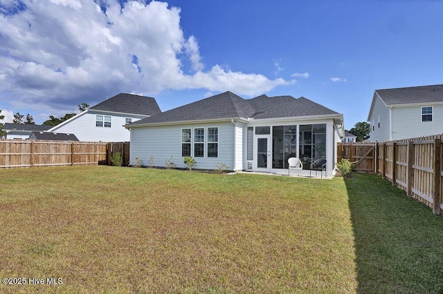 back of house featuring a sunroom and a yard