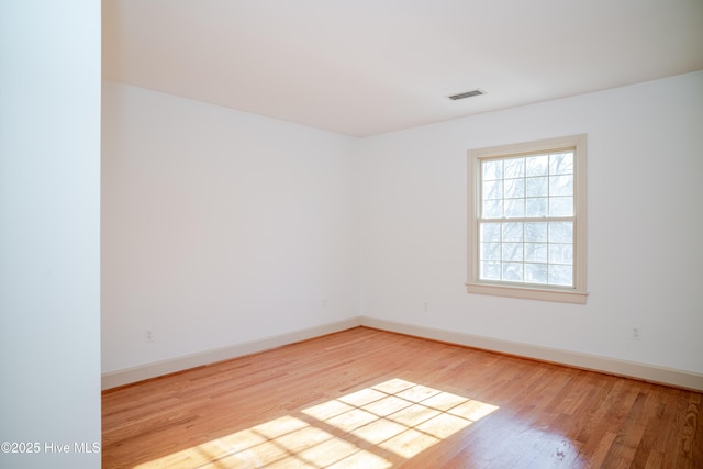 spare room with hardwood / wood-style floors