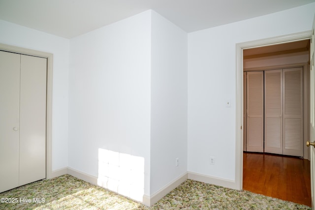 unfurnished bedroom featuring carpet flooring and a closet