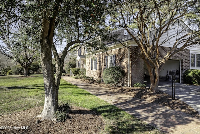 view of front of home featuring a garage and a front lawn