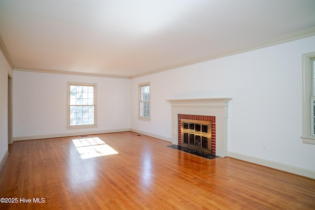 unfurnished living room with crown molding, a fireplace, and light hardwood / wood-style floors