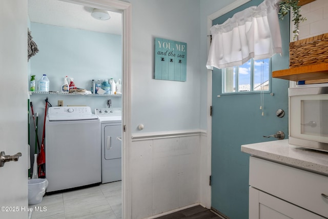 clothes washing area with washer and clothes dryer