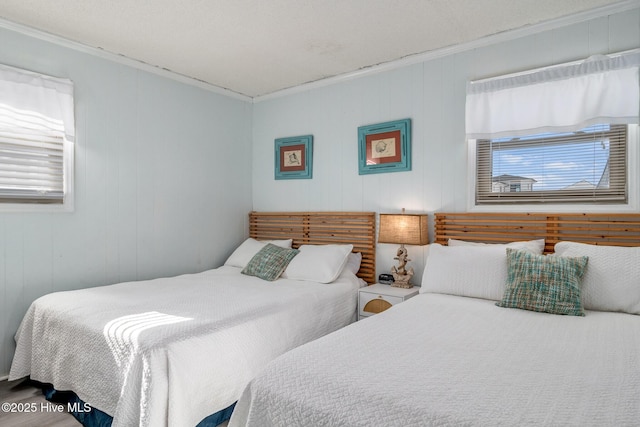 bedroom featuring crown molding and wooden walls