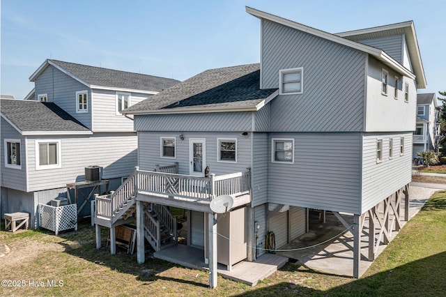 back of house with a wooden deck and a yard