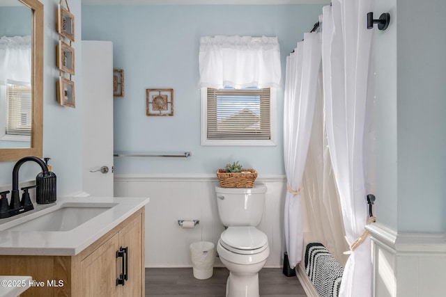 bathroom featuring vanity, toilet, and hardwood / wood-style floors