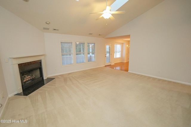 unfurnished living room featuring light carpet, baseboards, visible vents, and a high end fireplace