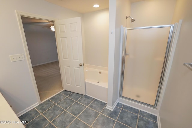 full bathroom with tile patterned flooring, a garden tub, a shower stall, and baseboards