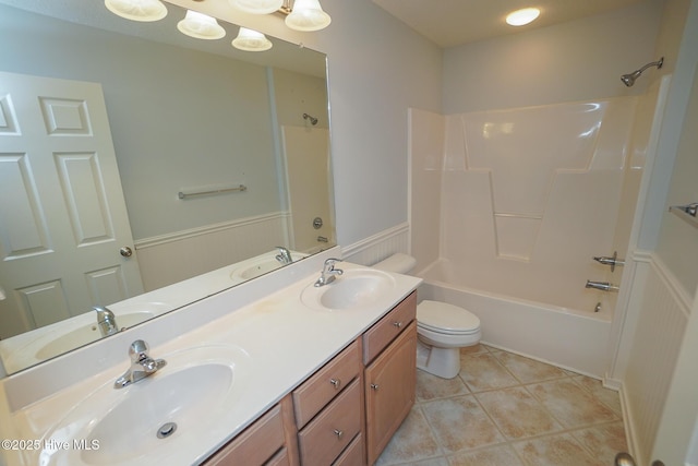 full bathroom featuring a sink, toilet, and tile patterned floors