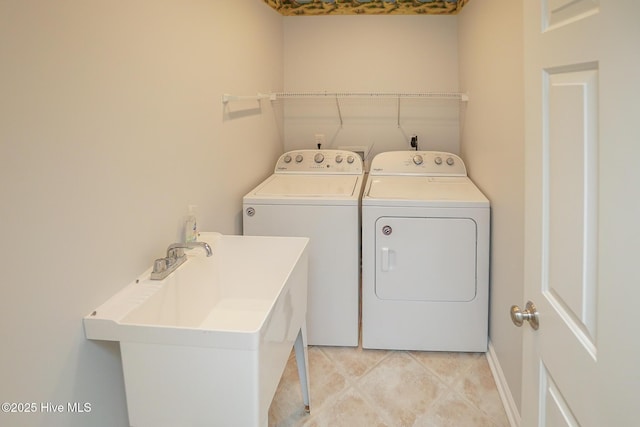 laundry area with a sink, laundry area, and washer and dryer