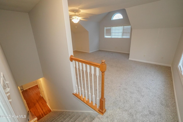 bonus room featuring vaulted ceiling, carpet flooring, a ceiling fan, and baseboards