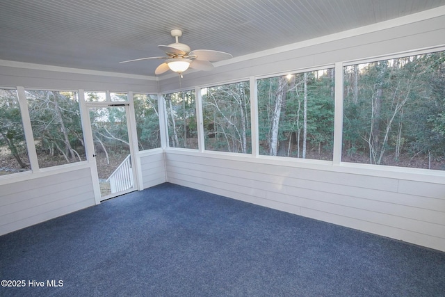 unfurnished sunroom with a ceiling fan