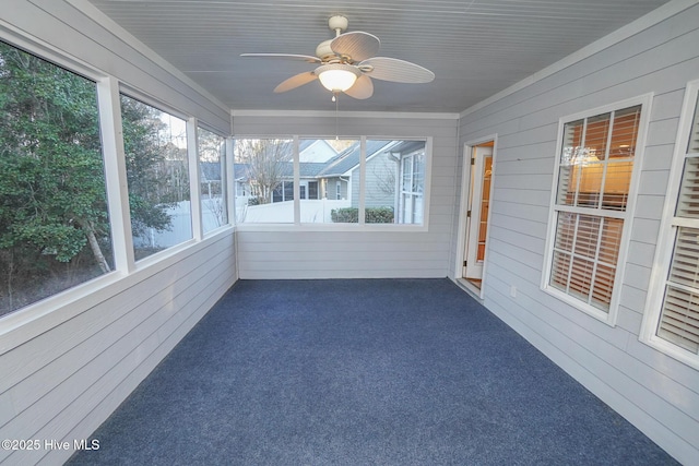 unfurnished sunroom with ceiling fan