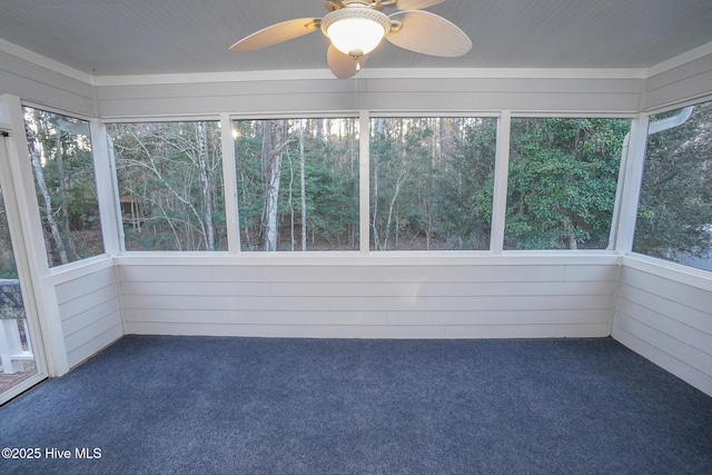 unfurnished sunroom with a ceiling fan