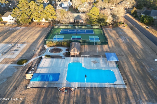 view of pool with a tennis court