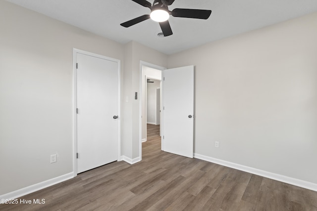 unfurnished bedroom featuring wood-type flooring and ceiling fan