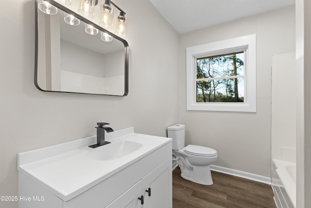 full bathroom featuring vanity, hardwood / wood-style flooring, shower / tub combination, and toilet