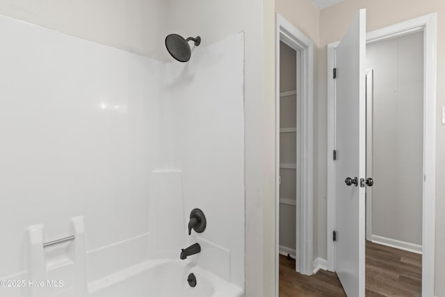 bathroom featuring  shower combination and wood-type flooring