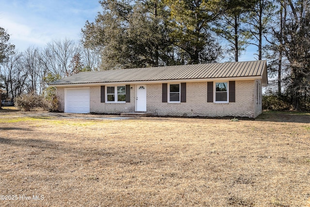 ranch-style house with a garage and a front lawn